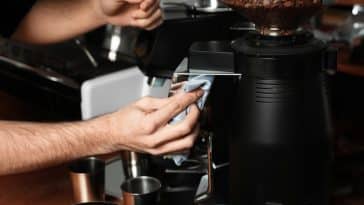 Homme nettoyant machine expresso